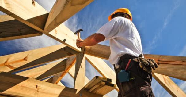 roofer ,carpenter working on roof structure at construction site